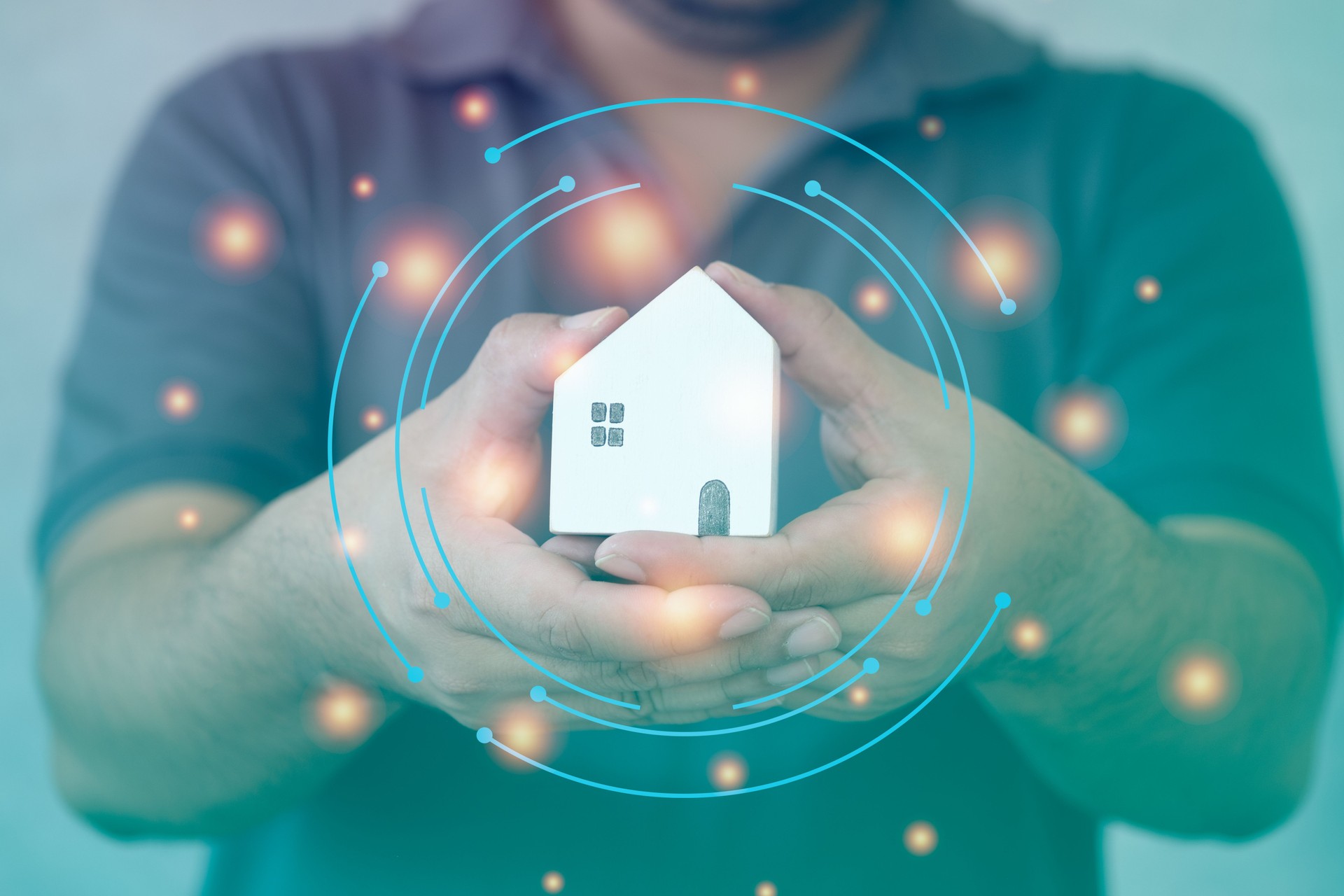 Man hand hold mini wood house model protecting with a virtual digital interface